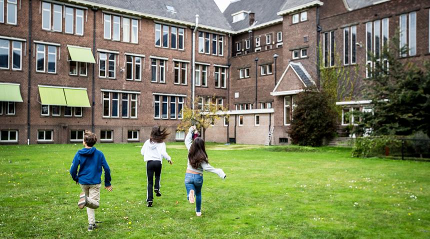 Children running toward a school