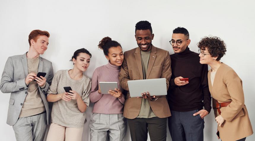 group of people looking at laptop screen