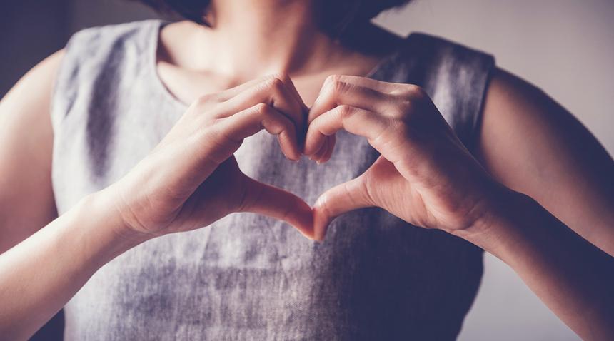 Woman signing a heart with her hands