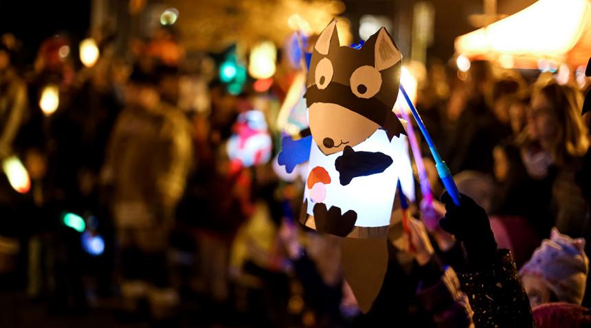 Child holding up a hand-made lantern