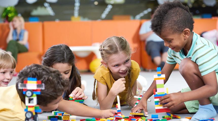 Diverse group of children playing with Lego