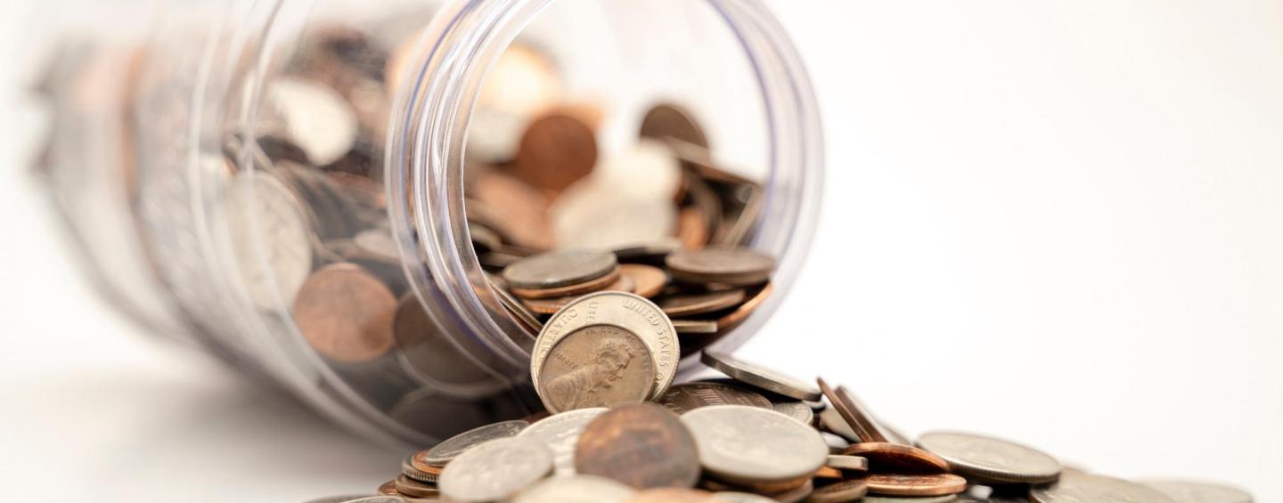 Coins spilling jar