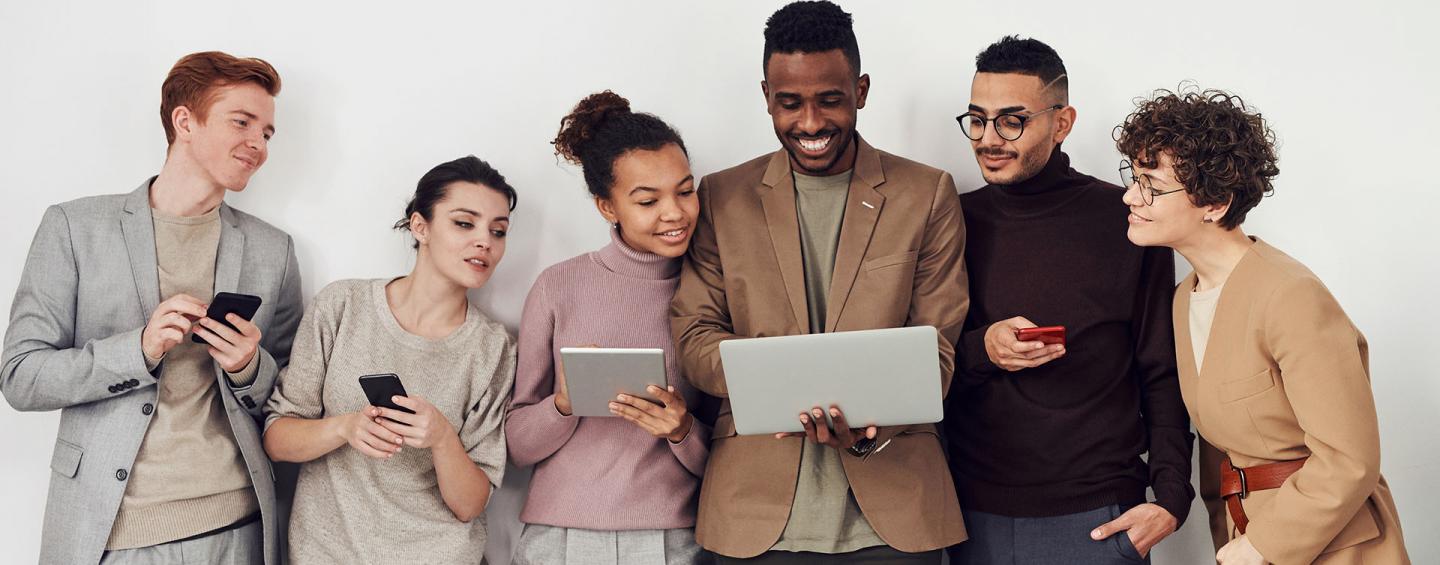 group of people looking at laptop screen