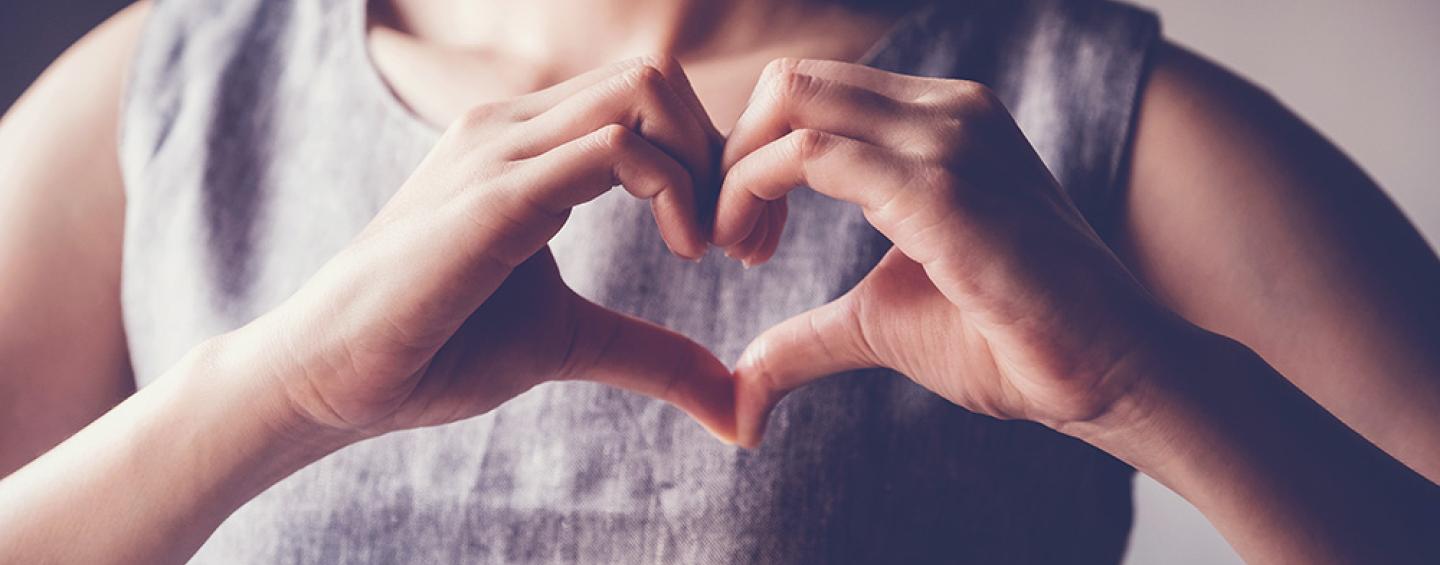 Woman signing a heart with her hands