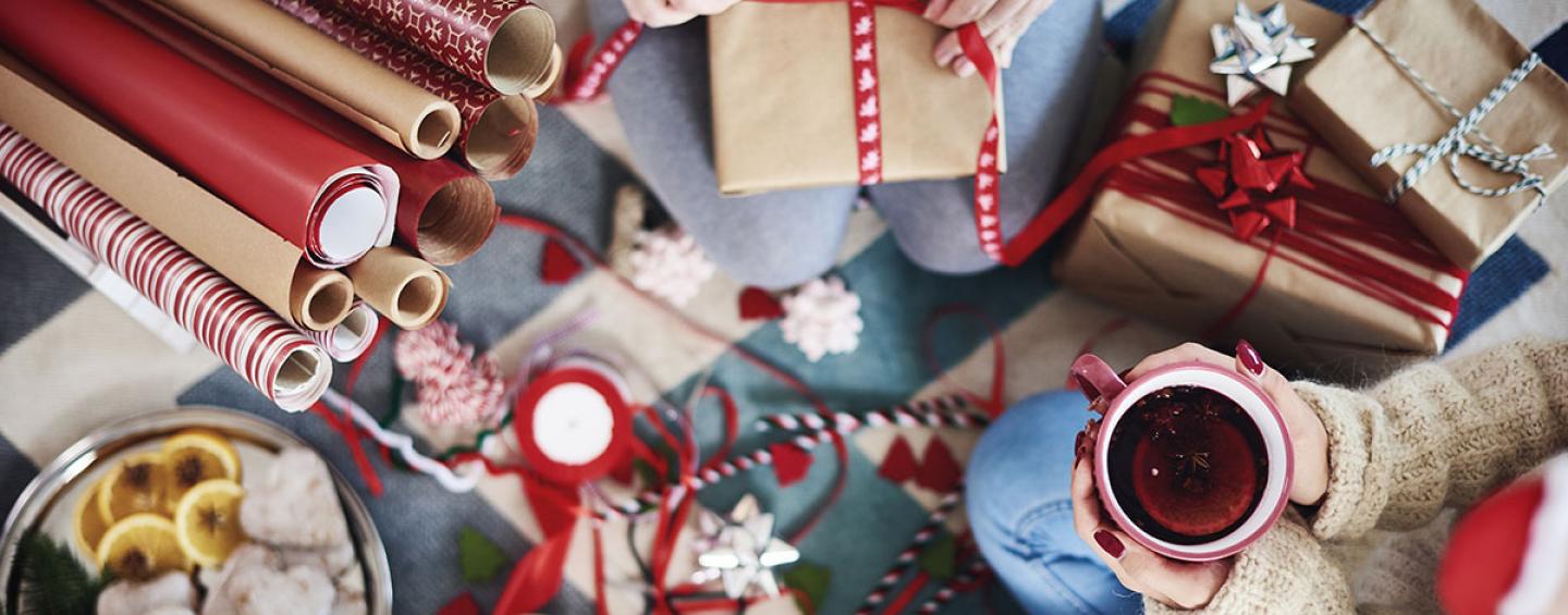 People wrapping Christmas gifts