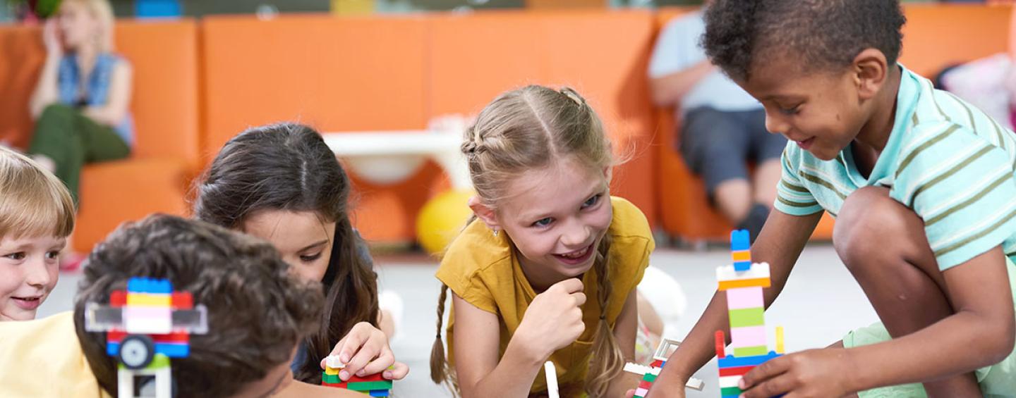 Diverse group of children playing with Lego