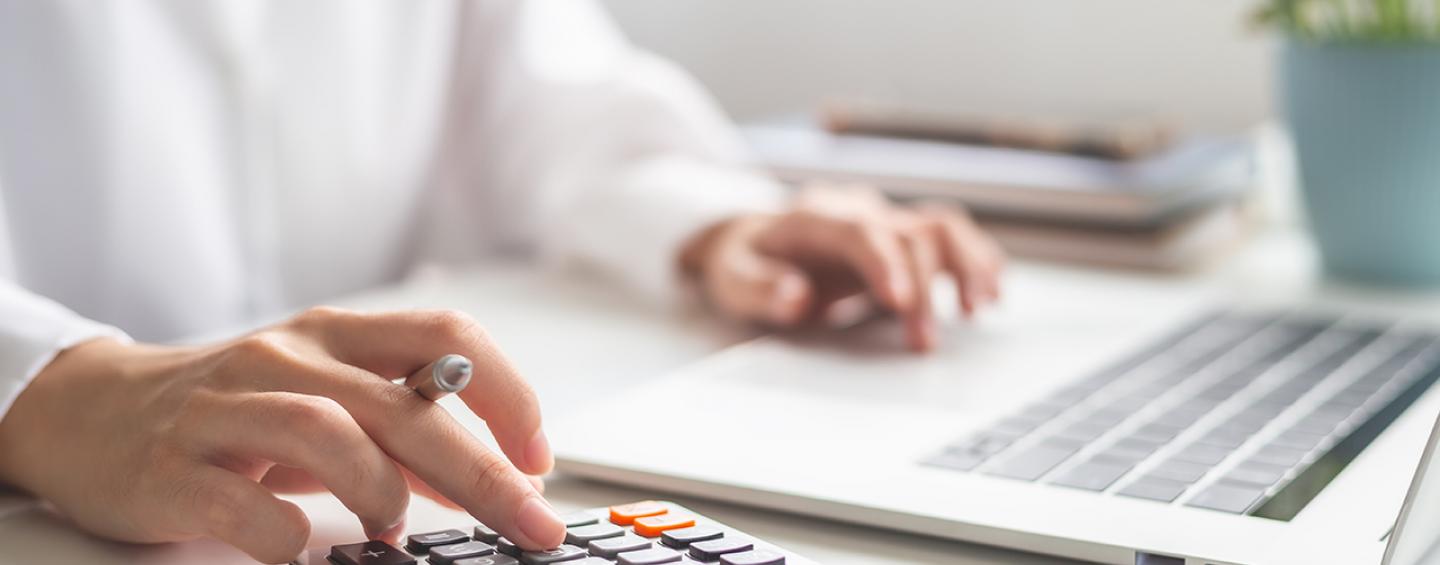 woman with laptop and calculator