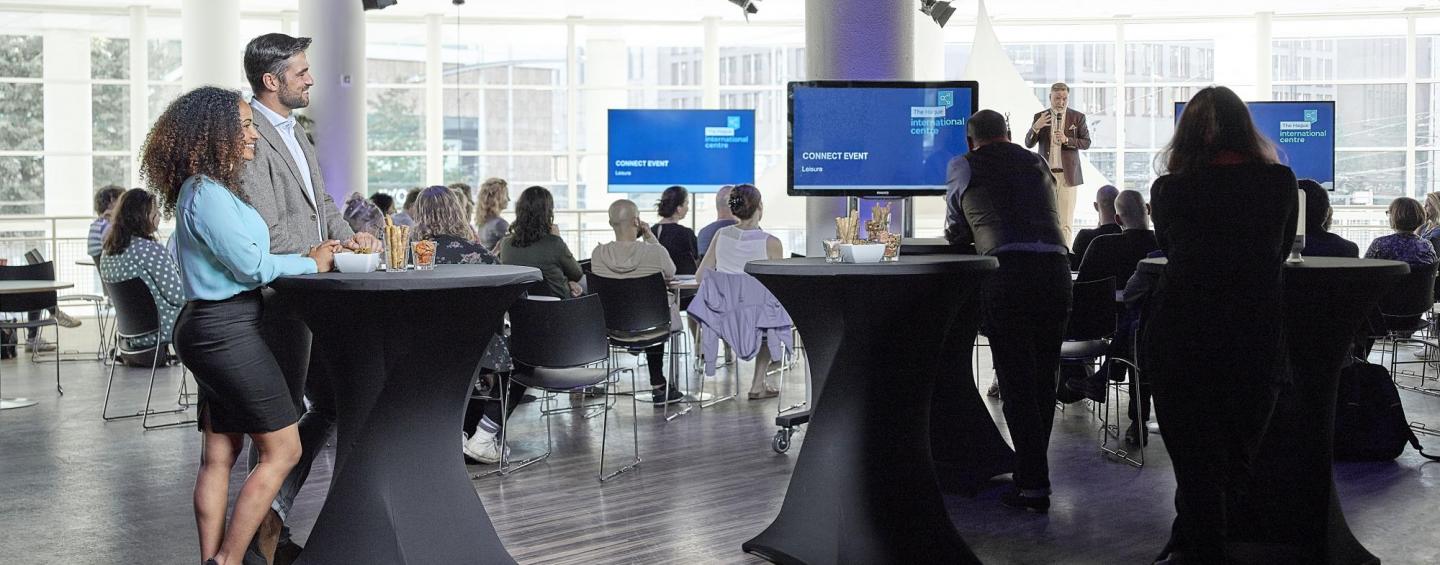 man and woman looking at screens